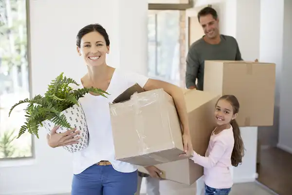 family moving in carrying boxes