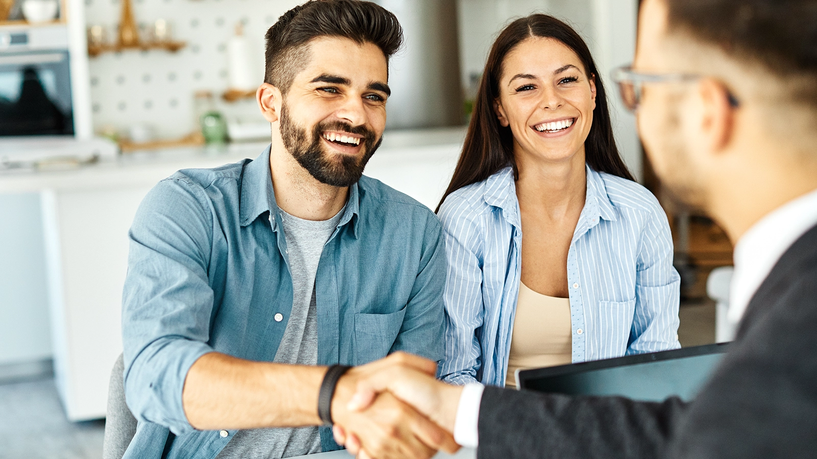 couple shaking hands with lender