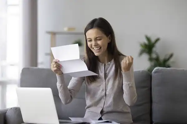 excited girl holding approval letter for a loan