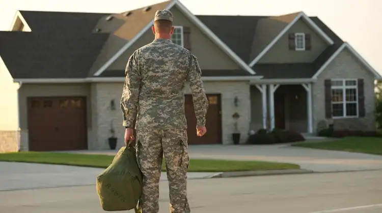 military veteran front of home