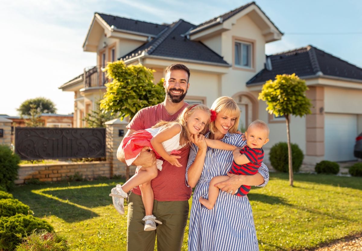 A young military family in front of the home they bought near Camp Lejeune with a VA loan from PBT Bancorp