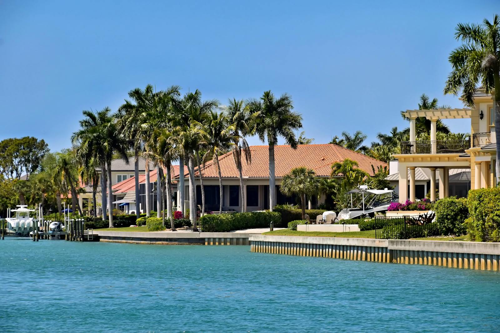 Upscale waterfront homes with palm trees, the kind of higher-priced property a VA high-balance loan can finance