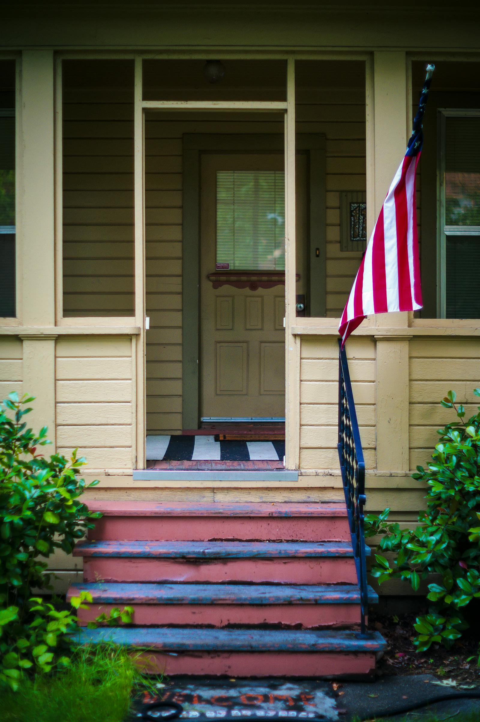 Newly built suburban home flying an American flag, representing the homes Veterans buy and build with VA loans from PBT Bancorp