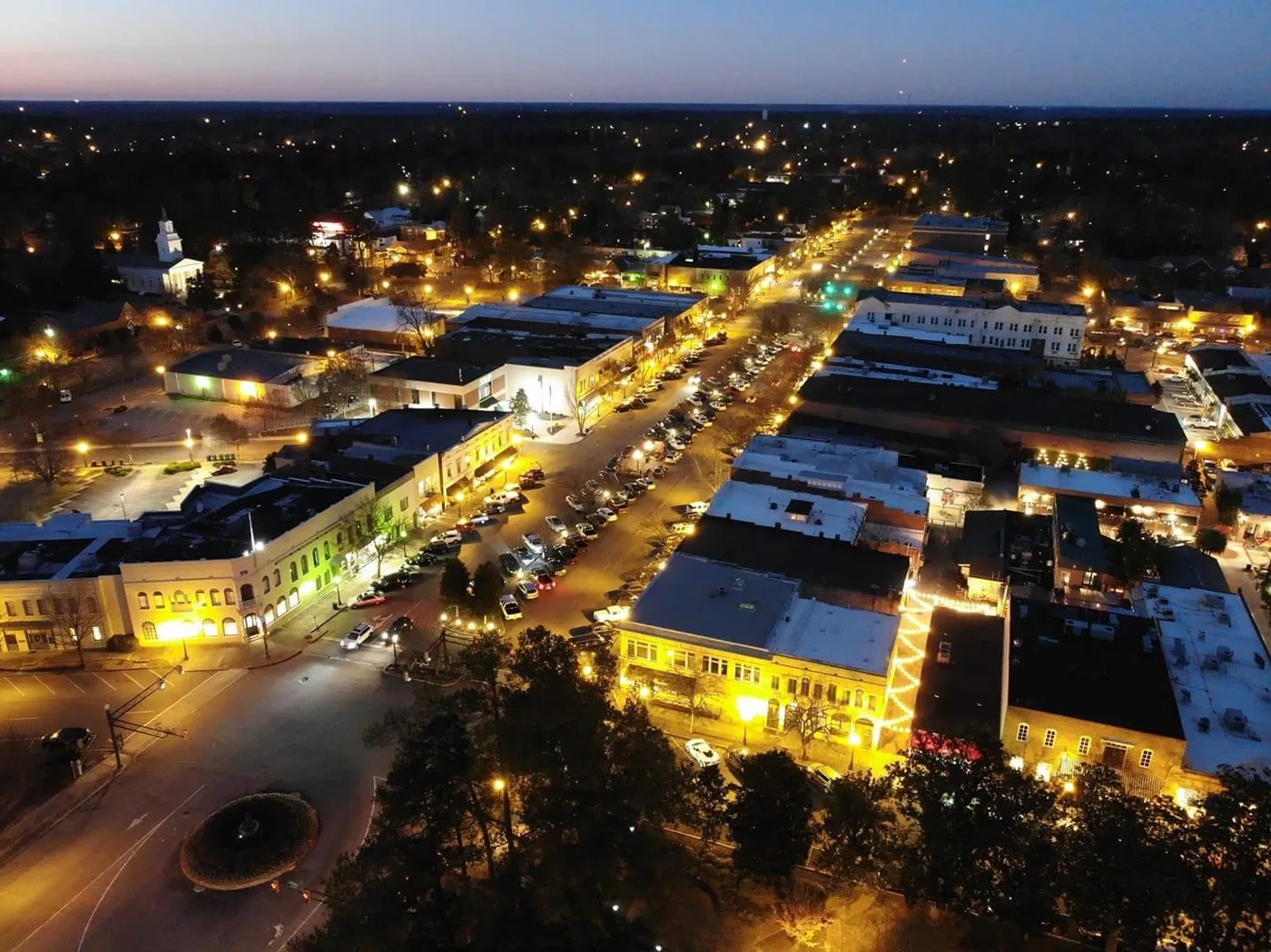 Twilight aerial view of the tree-lined parkways of downtown Aiken, South Carolina, where PBT Bancorp helps Fort Gordon commuters and Veterans buy homes with VA loans