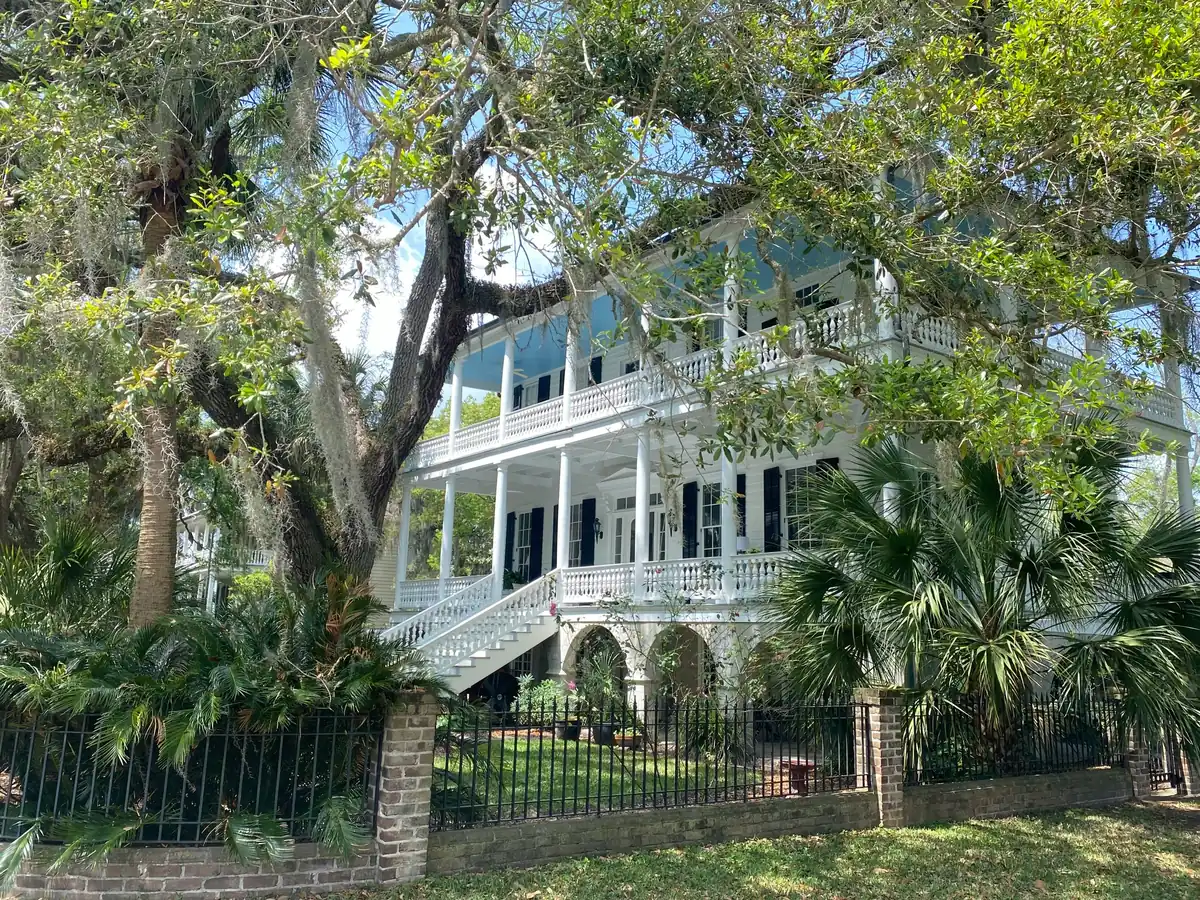 Historic white double-porch home beneath live oaks with Spanish moss in Beaufort, South Carolina, the kind of Lowcountry home Veterans buy with VA loans from PBT Bancorp
