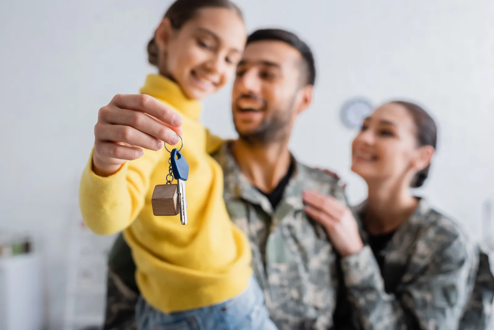 North Carolina military family holding the key to a newly built home financed with a VA one-time close construction loan from PBT Bancorp