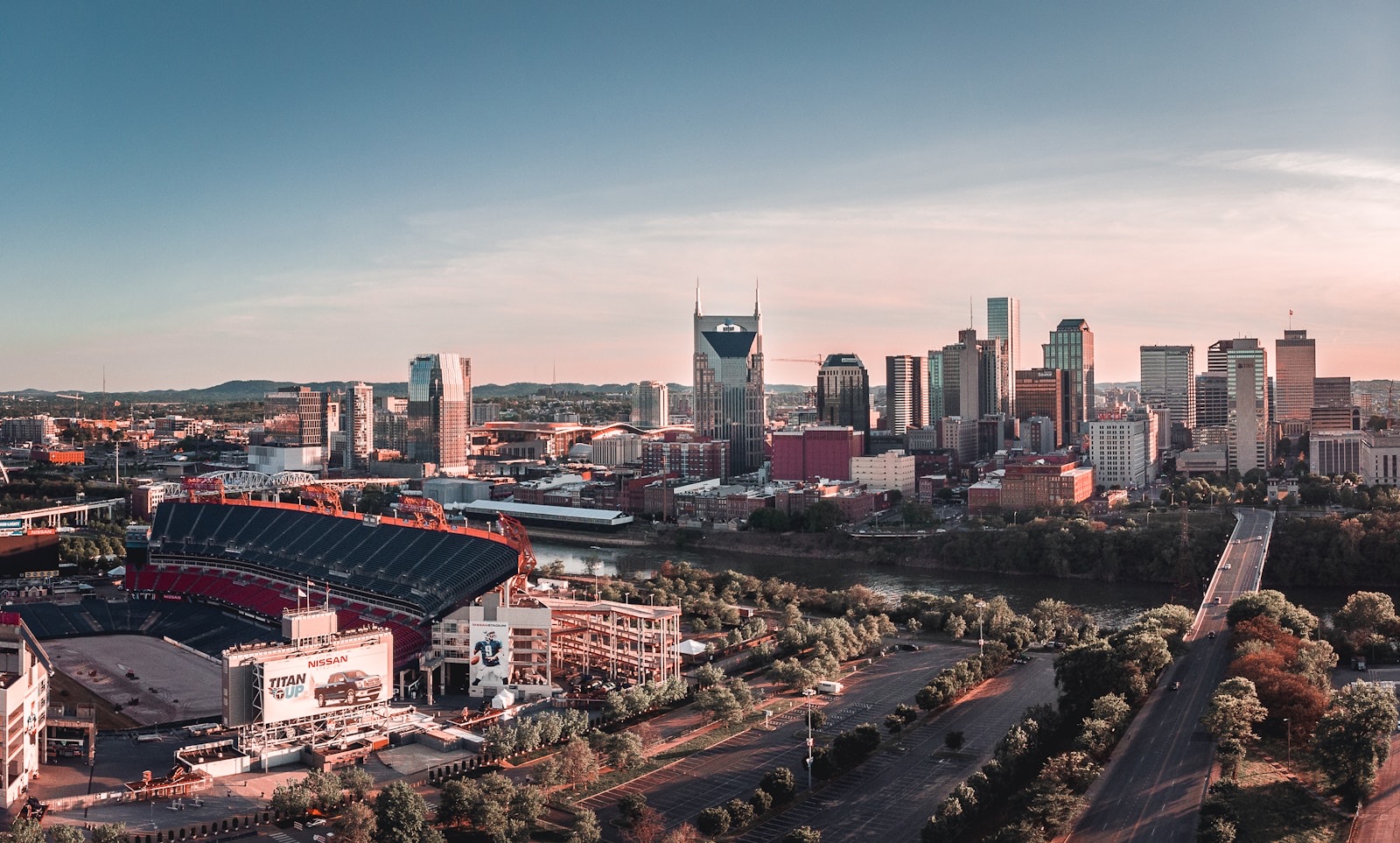 The downtown Nashville, Tennessee skyline at golden hour with Nissan Stadium and the Cumberland River, where PBT Bancorp helps Veterans buy homes with VA loans
