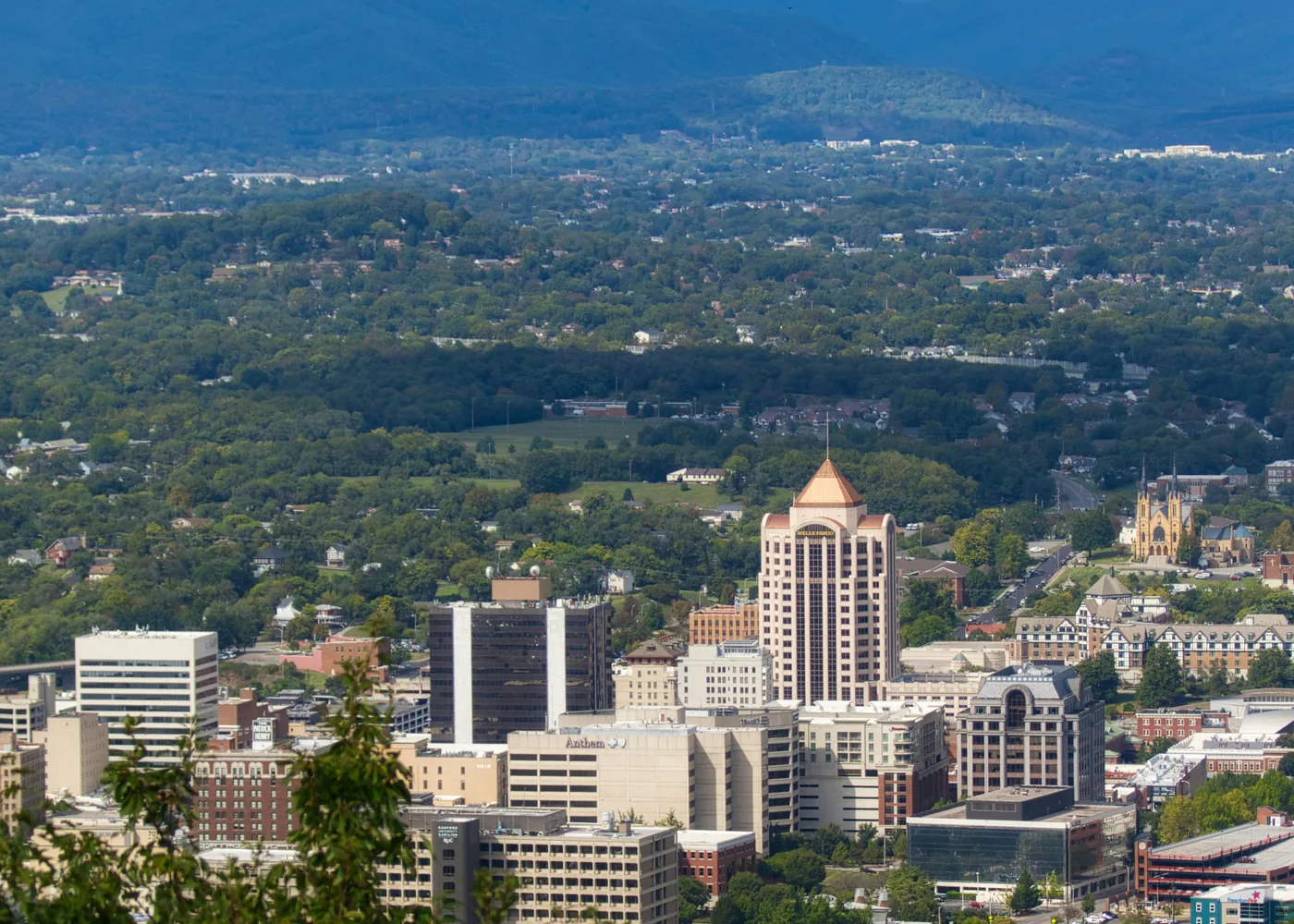 Downtown Roanoke, Virginia skyline in the valley beneath the Blue Ridge Mountains, where PBT Bancorp helps Veterans across the Roanoke Valley buy homes with VA loans