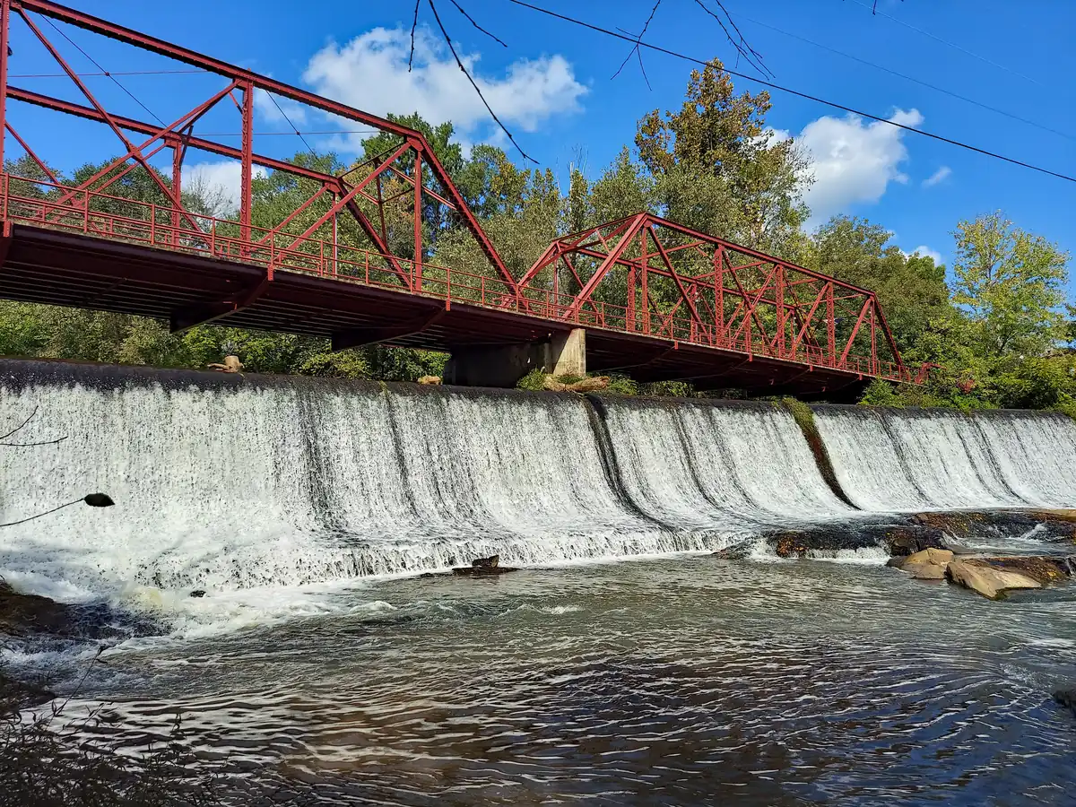 Glendale Shoals waterfall and the historic red truss bridge near Spartanburg, South Carolina, where PBT Bancorp helps Veterans buy homes with VA loans
