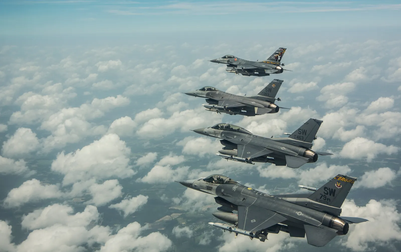 Four 20th Fighter Wing F-16s from Shaw Air Force Base flying in formation above the clouds near Sumter, South Carolina, U.S. Air Force photo