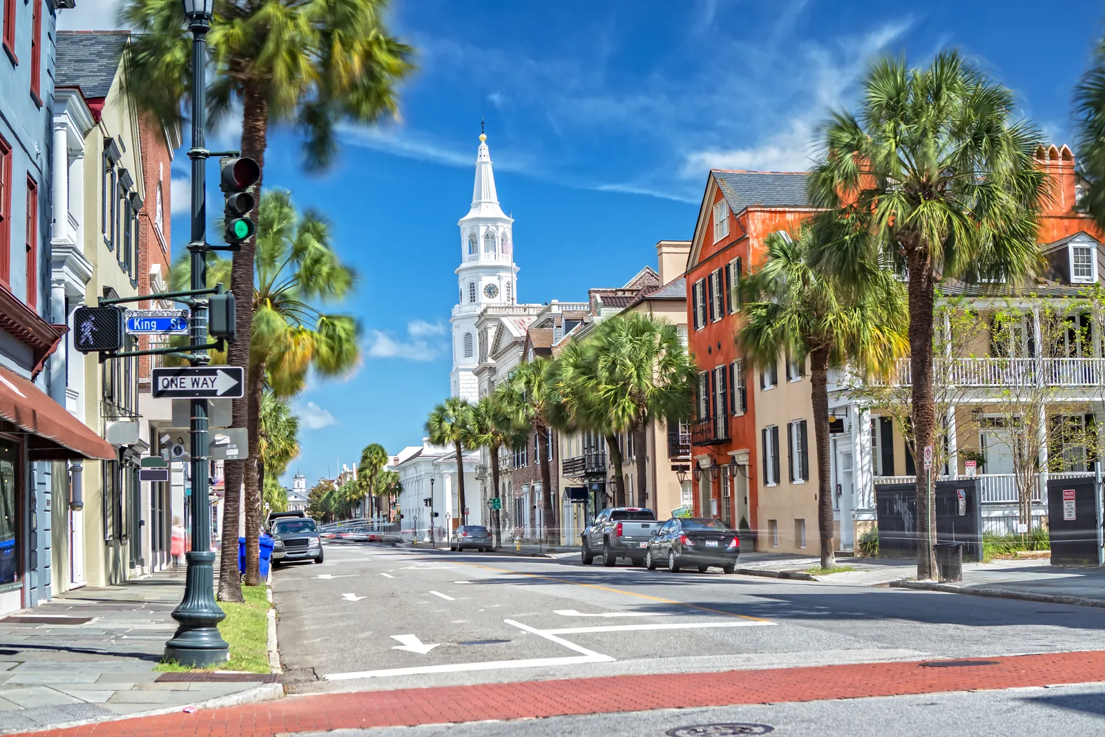 Historic King Street in downtown Charleston with palm trees and St. Michael's Church