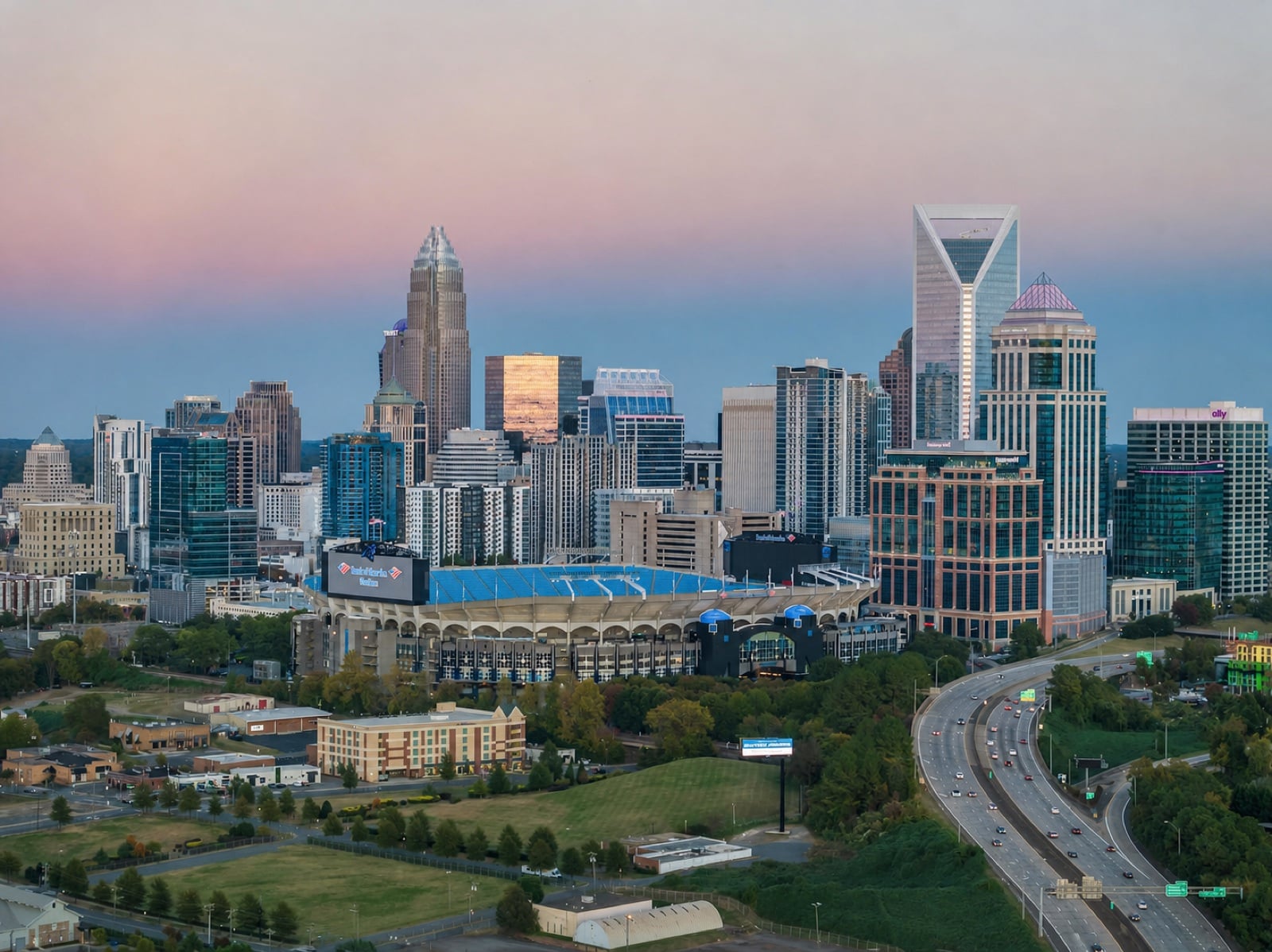 Charlotte skyline and Bank of America Stadium at dusk