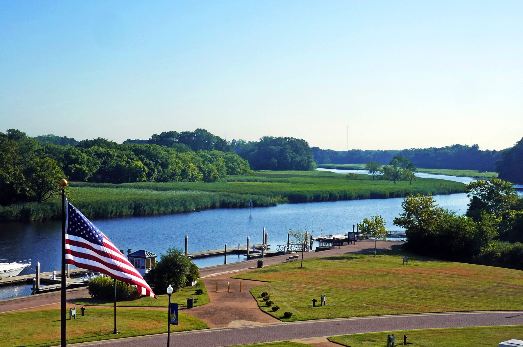 Nansemond River waterfront in Suffolk, Virginia, with a marina, park, and American flag